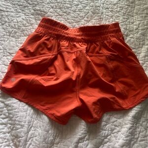 Orange lululemon running shorts